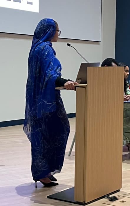 Ala'a Tamam speaking on a panel for the White Nile Youth Association